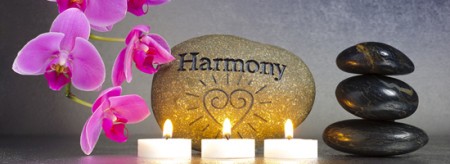 Stone with Harmony on, with orchids, candles and Zen pebbles
